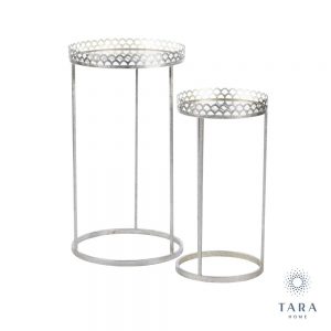 The key feature of these pretty mirrored tables is the 'frill' at the top, which is designed to keep whatever is on top safely in place.